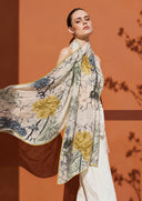 DLUX Spring Foliage multicolour cotton silk scarf flowing from a model against a terracotta backdrop